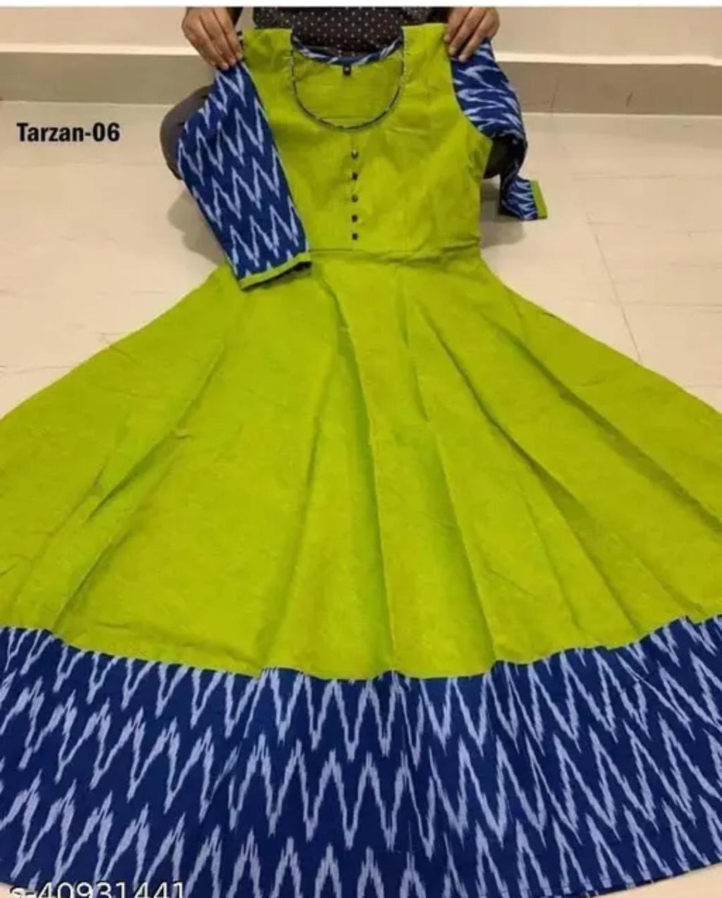 Green dress gown close-up with button placket, blue zigzag yoke border, flared skirt