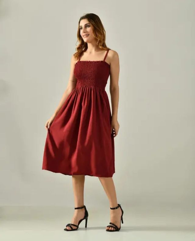 Maroon sleeveless smocked knee-length dress with gathered skirt