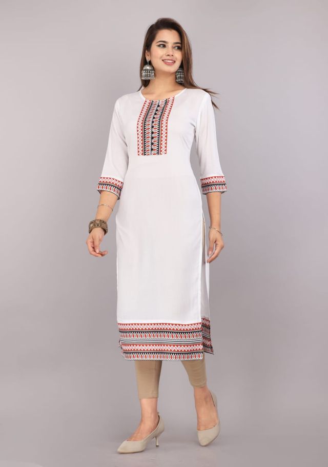 Women's white kurti with red-blue yoke embroidery, patterned cuffs, and hem border