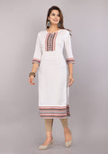 Women's white kurti with red-blue yoke embroidery, patterned cuffs, and hem border