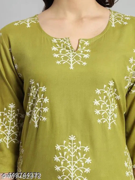 Green short kurti close-up: round neckline keyhole slit with white printed motifs